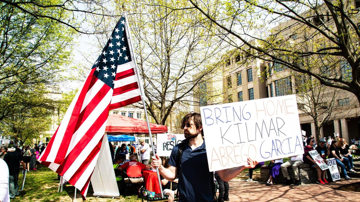 A man holds the American flag and a sign demanding the return of Kilmar Abrego Garcia, the Maryland man mistakenly deported to El Salvador by ICE, during the “No Kings Then, No Kings Now” Peaceful March and Protest in front of the Robert F. Stephens Courthouse, downtown Lexington, Ky, on April 19, 2025.