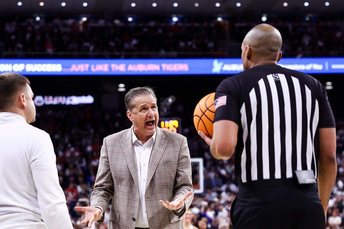 Kentucky head coach John Calipari talks with a referee after a play against Auburn during Saturday’s game.