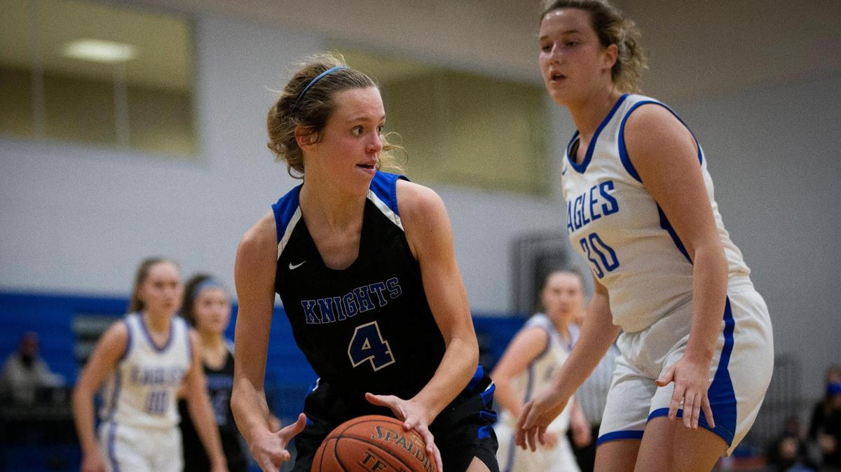 Lexington Catholic’s Katherine Truitt (4) is guarded by Lexington Christian’s Emilie Teall (30) during a possession in the Knights’ 39-23 win over the Eagles at Lexington Christian Academy on Friday, Jan. 15, 2021. Truitt had a team high nine points.