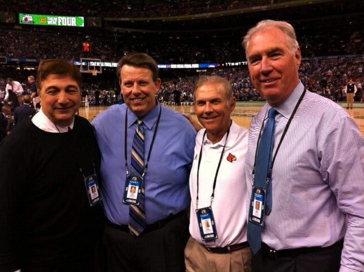 University of Louisville color analyst Bob Valvano, University of Kentucky play-by-play voice Tom Leach, U of L play-by-play man Paul Rogers and UK color analyst Mike Pratt posed for a photograph before UK beat U of L in the 2012 NCAA Tournament Final Four in New Orleans.