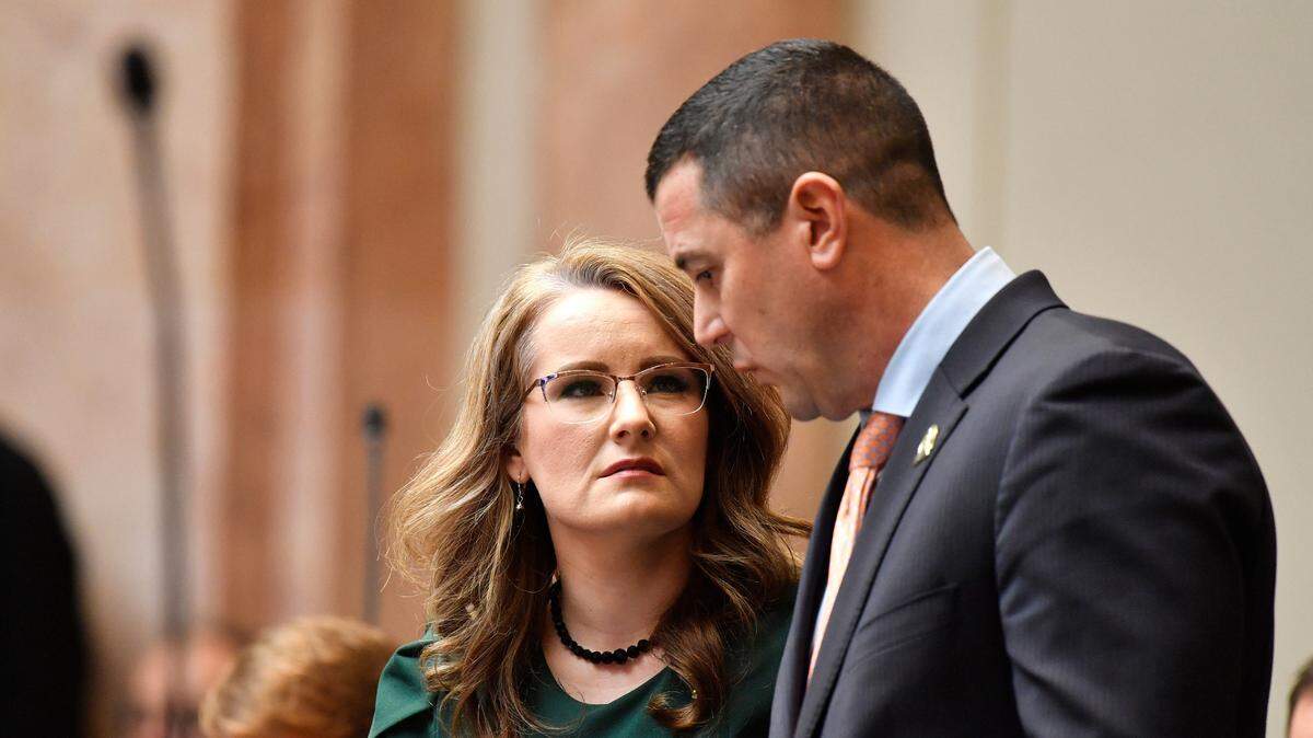 Kentucky House of Representatives members Savannah Maddox, left, speaks with Representative David Meade about Senate Bill 150 at the Kentucky House of Representatives in Frankfort, Ky., Thursday, March 16, 2023. The legislation was snuck into a last-minute committee meeting and then heard on the floor the same day. (AP Photo/Timothy D. Easley)