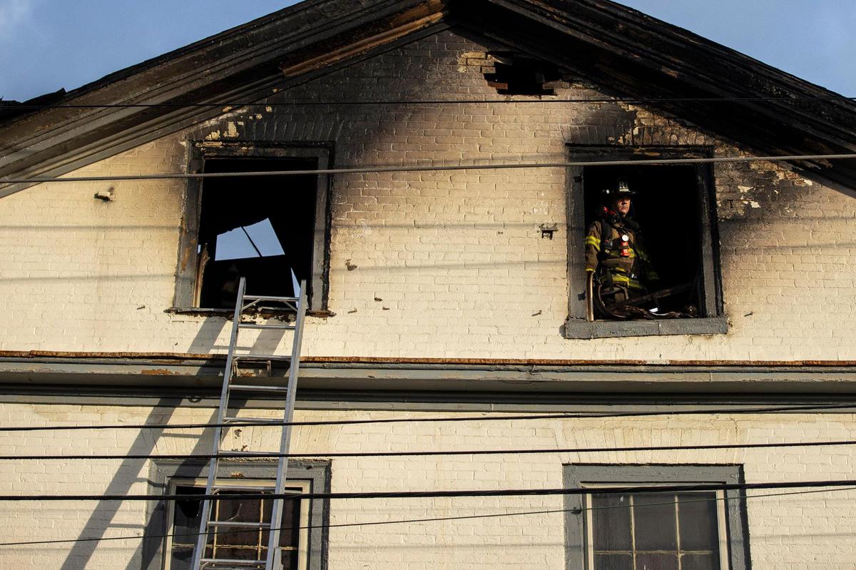 Members of the Lexington Fire Department respond to a structure fire at the corner of North Upper and West Second streets in downtown Lexington, Ky., on Thursday, March 31, 2022.