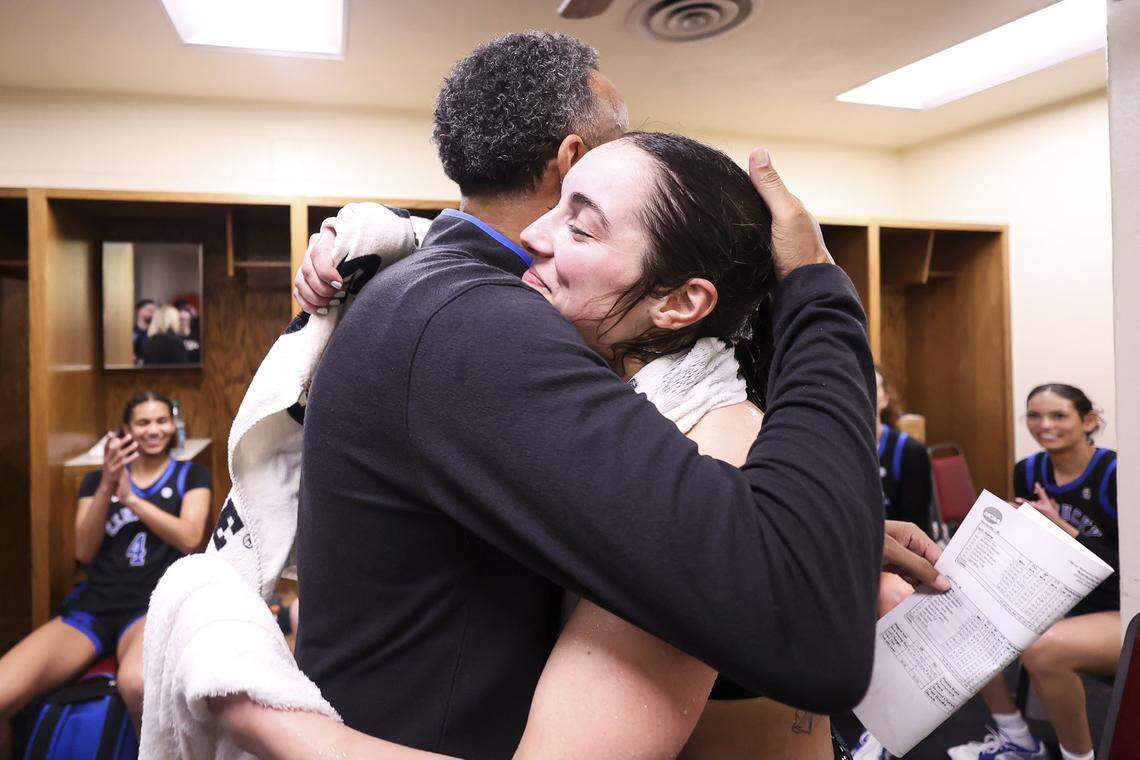 Kentucky coach Kenny Brooks hugs point guard Georgia Amoore after her career-high 43 points led the Wildcats to victory at No. 13 Oklahoma on Sunday.