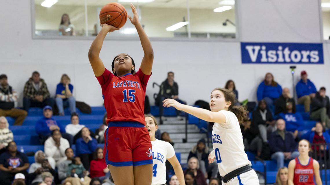 Lafayette’s Addi Combs (15) puts up a shot in front of Lexington Christian’s Payton Buckler, right, during the Generals 45-37 win at Lexington Christian Academy on Monday.