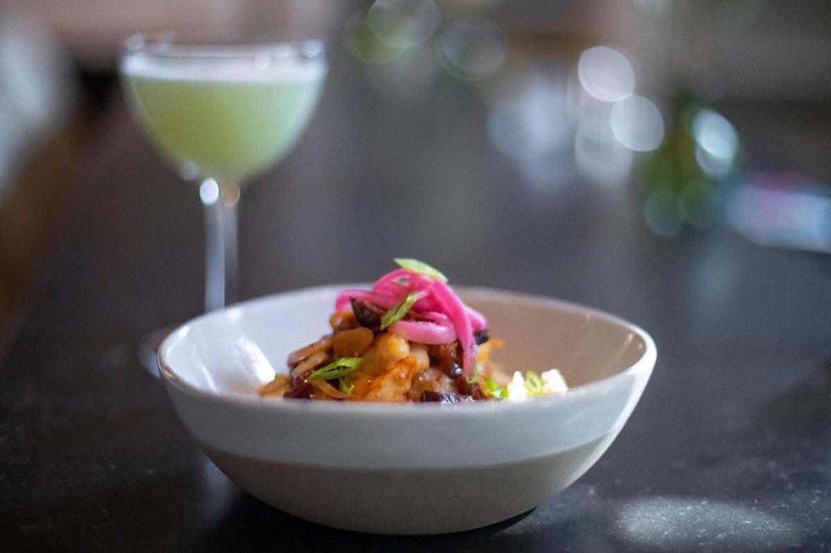The shrimp and stone-cut grits include roasted tomatoes, Sig Luscher beer jus and scallions at Limewater at 900 Wilkinson Blvd. in Frankfort, Ky. Wednesday, Sept. 28, 2022.