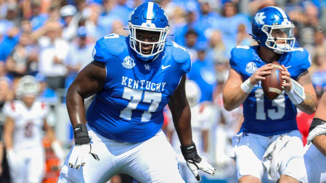 Jeremy Flax (77) and the UK offensive line have kept quarterback Devin Leary (13) upright this season, allowing only four sacks through the first four games.