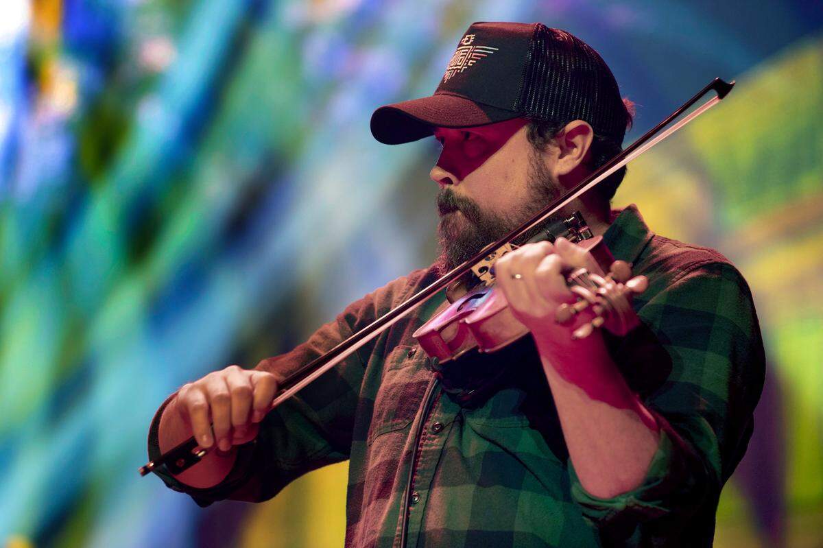 Morehead State University traditional music instructor Jesse Wells performs in Tyler Childers’s Foodstamp band Friday, Feb. 7, 2020, at the Ryman Auditorium in Nashville, Tenn. Childers is in the middle of a two-weekend residency on the famous stage. Wells, billed as The Professor, has traveled the world with his fellow eastern Kentuckian.