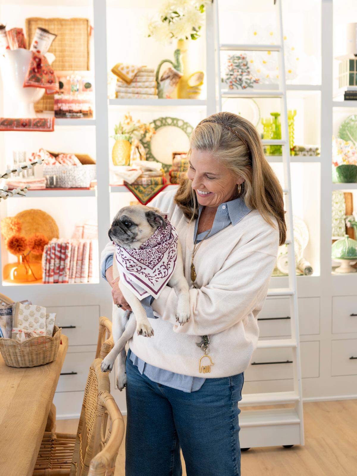 Pomegranate founder and creative director Angela Beck, with her pug Penelope, in the new store opening at 700 E. Main St. in Lexington on Dec. 3. Pomegranate also will have a cafe, Penny’s at Pomegranate, serving a menu created by chef Ouita Michel and wines from Beck’s Oregon vineyard.