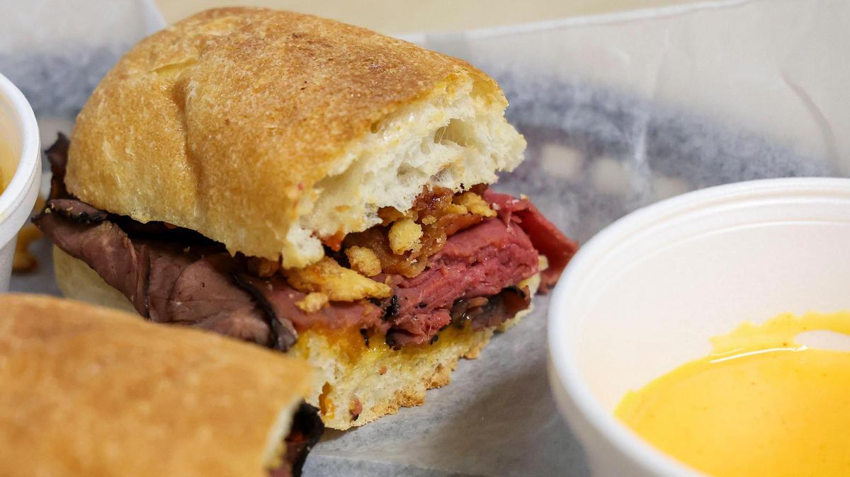 The Rushmore sandwich at Dad’s Favorites Deli, Thursday, June 26, 2025 in Lexington, Ky. The sandwich, available Thursday and Fridays only, is one of the most popular the sandwich shop has and frequently sells out. It has chipotle cheddar cheese spread, sliced roast beef, BBQ sauce, bacon, fried onion straws on toasted ciabatta and is served with beer cheese sauce for dipping.