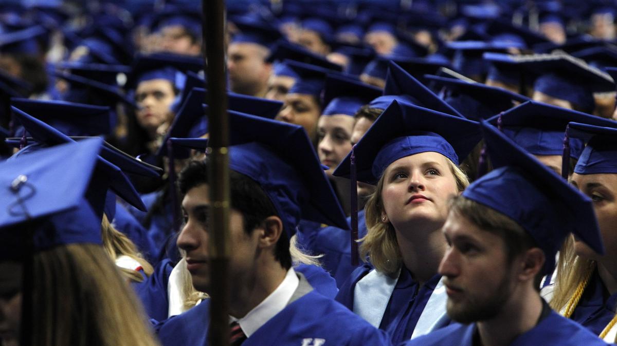 A grad looked to the stands Sunday morning during University of Kentucky’s commencement ceremony.