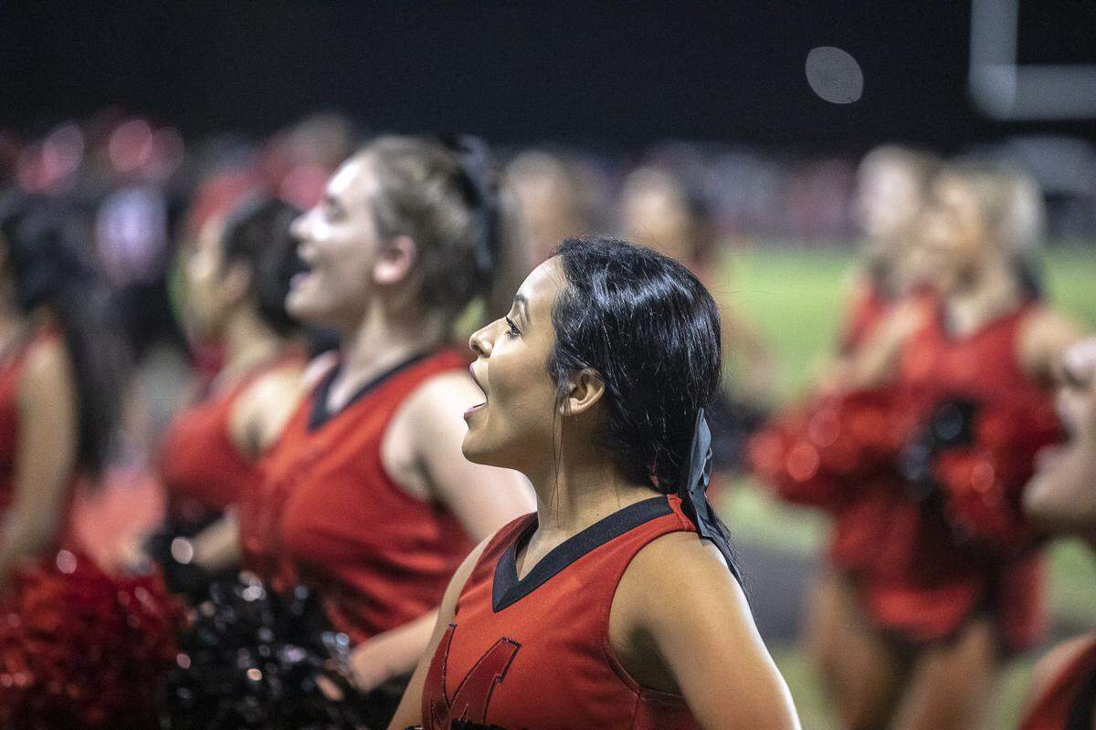 Mayfield cheerleader Marilu Delapaz, center, a senior, cheers during the game.