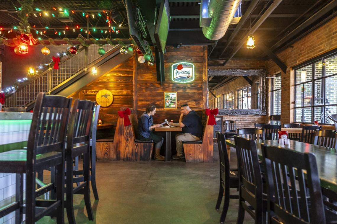 Holiday lights, garland, ornaments and more create a festive environment at the Bear and the Butcher in Lexington, Ky., on Thursday, Dec. 11, 2025.