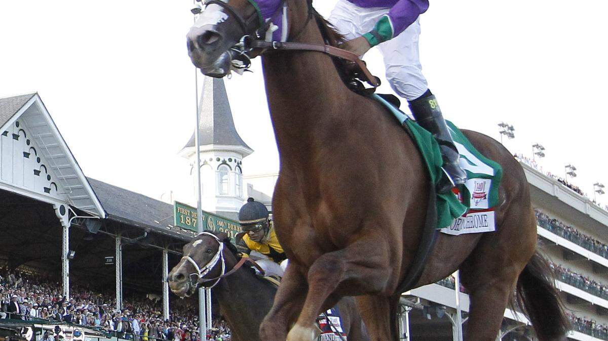 Jockey  Victor Espinoza celebrated on California Chrome after crossing the finish line. Photo by Mark Cornelison | Staff