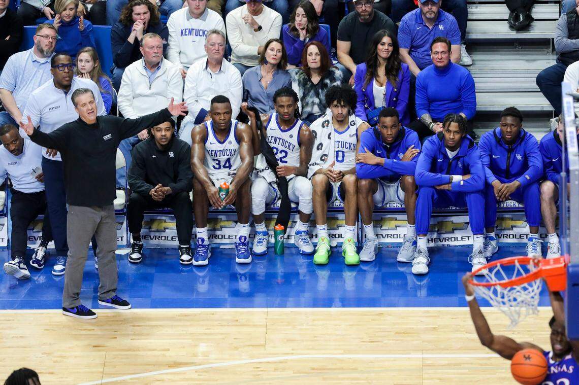 Kentucky head coach John Calipari and his players watch as a Kansas player dunks in the first half Saturday.