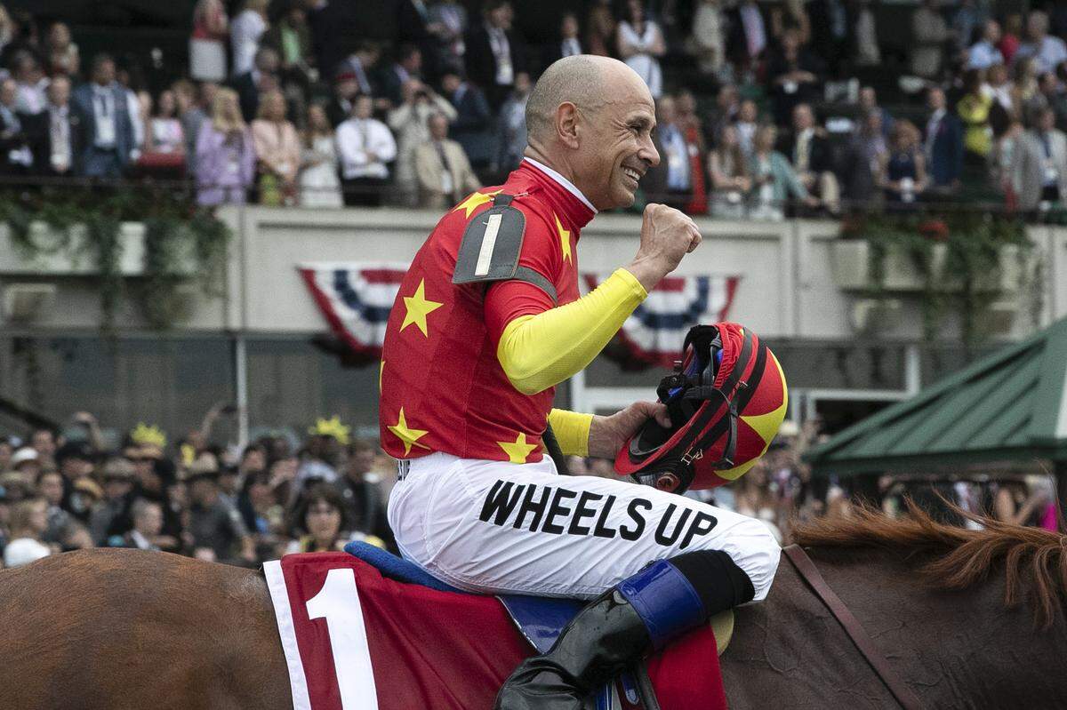 Mike Smith, atop Justify, celebrated after winning the 2018 Belmont Stakes at Belmont Park to become the 13th Triple Crown champion.