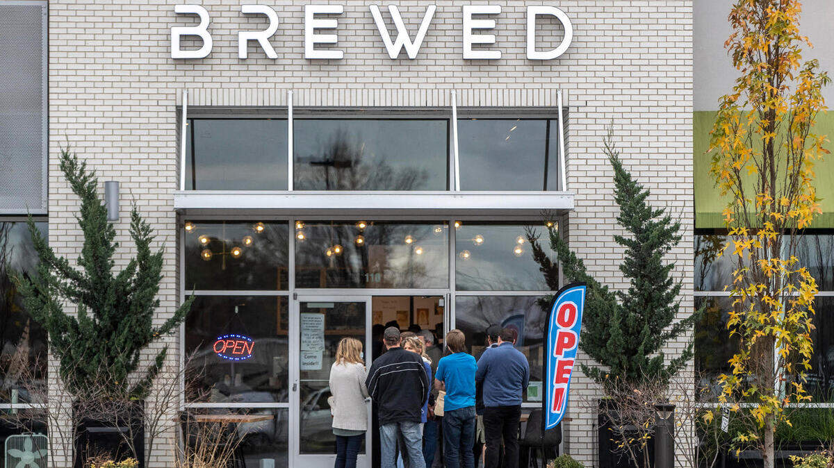 Customers, some of whom weren’t wearing masks, crowded into Brewed at 124 Malabu Drive in Lexington, Ky., on Wednesday, Nov. 25, 2020. The Lexington health department ordered the coffee shop to close for not complying with COVID-19 emergency orders to halt indoor dining.