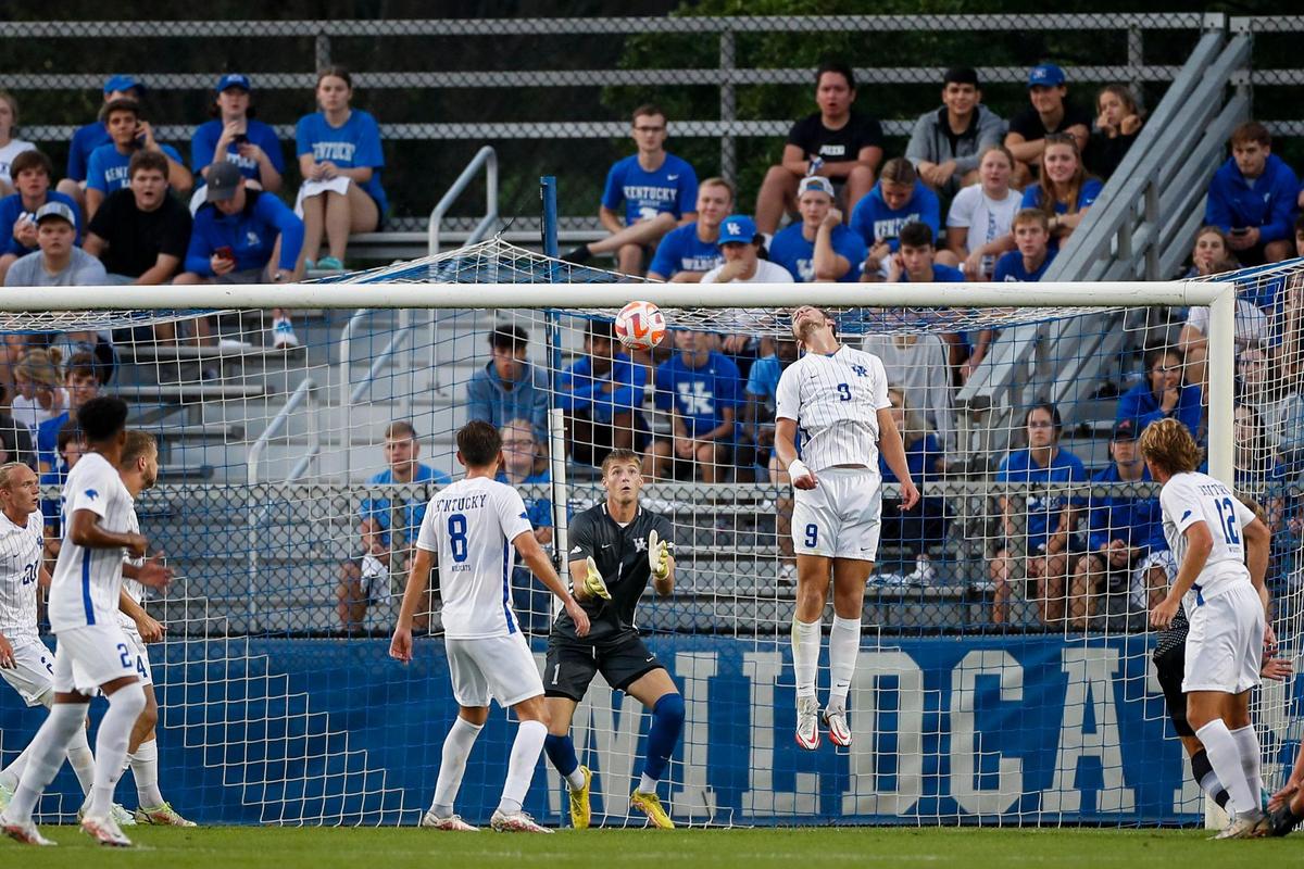Kentucky goalkeeper Casper Mols (1) looks to block a shot on goal by Louisville on Tuesday night. Kentucky allowed its first goals of the season against Louisville but still won the match, 3-2.