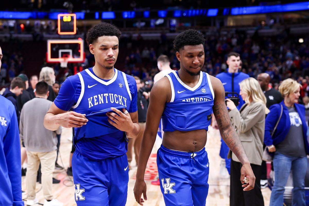Kentucky’s Tre Mitchell, left, and Justin Edwards walk off the court after their team’s loss to Kansas in the Champions Classic at the United Center in Chicago. MItchell finished with eight points and Edwards one.