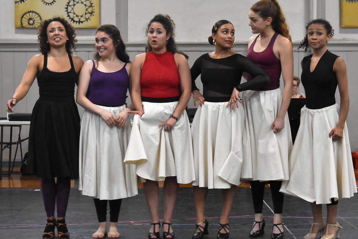 Michelle Alves (left) rehearses the musical number “America” with cast members at Artworks at the Carver School. The show opens Thursday and runs to Sunday at the Lexington Opera House.