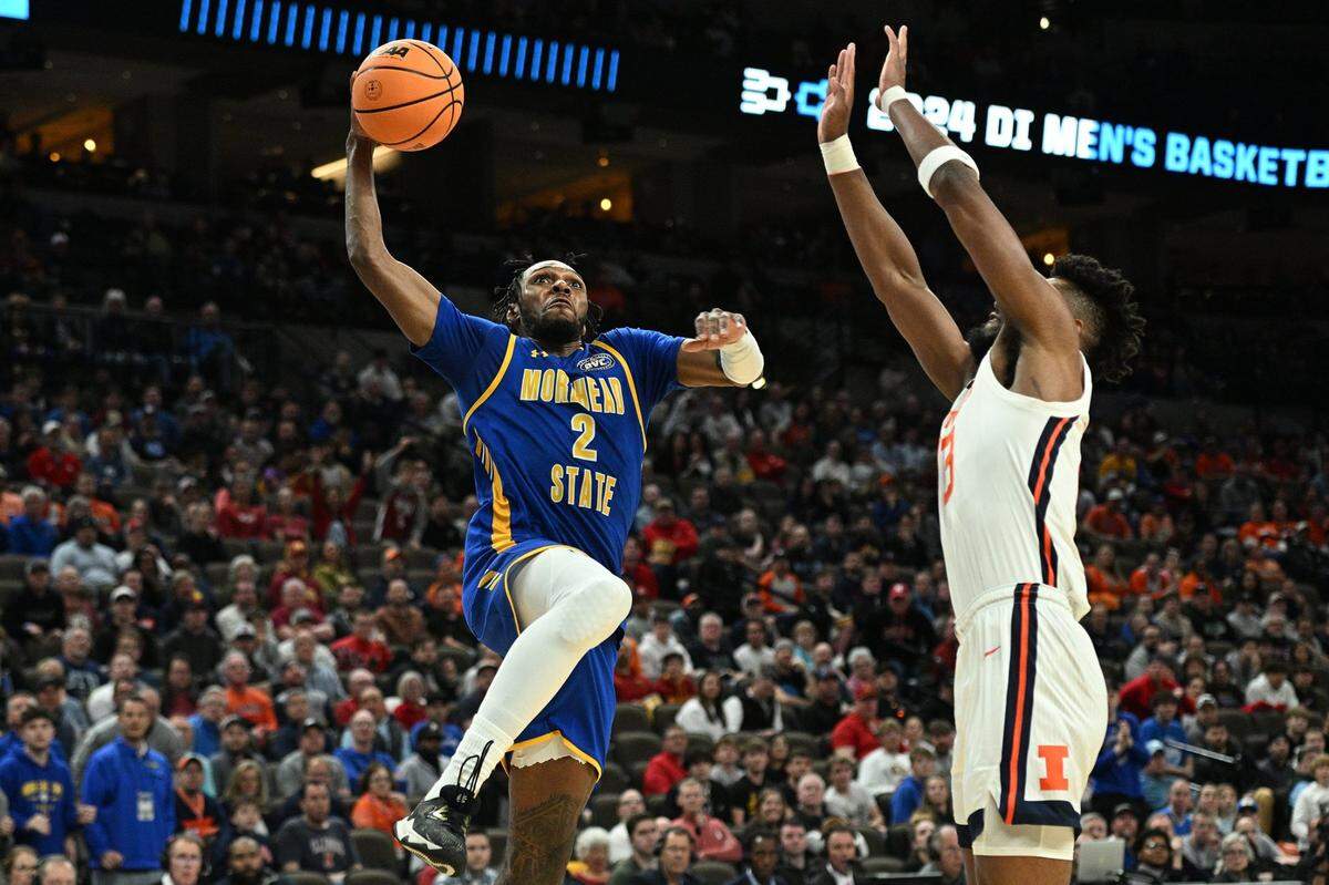 Morehead State’s Jordan Lathon (2) drives to the hoop against Illinois’ Quincy Guerrier (13) during the second half Thursday in Omaha, Nebraska.