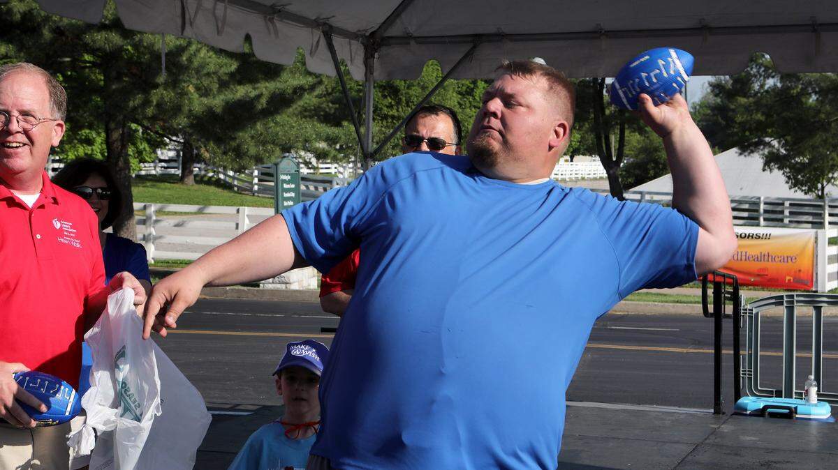 Jared Lorenzen threw a souvenir football during his visit to the Central Kentucky Heart Walk at Keeneland this summer.
