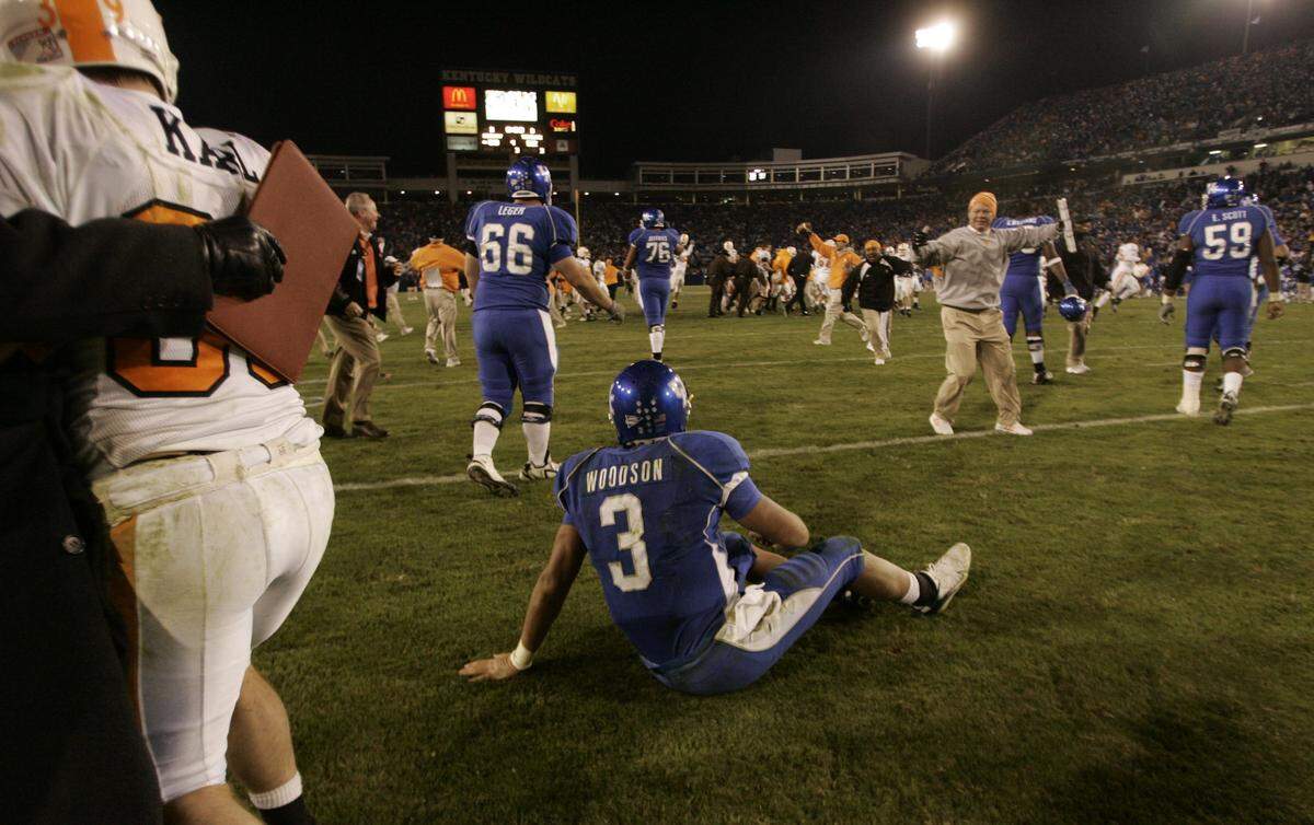 Kentucky quarterback Andre Woodson sat on the field at Commonwealth Stadium as Tennessee players celebrated following the final play of UT’s 52-50, four-overtime victory over UK in 2007.