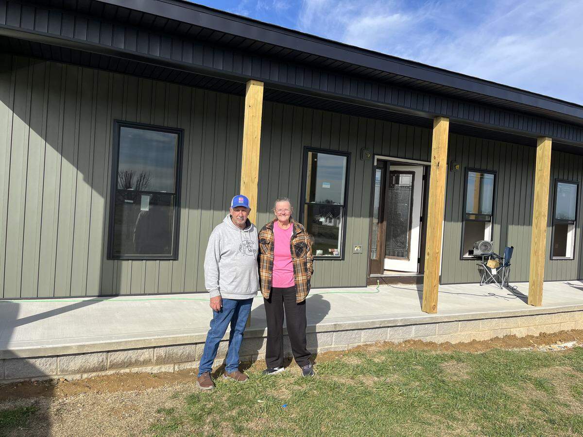 Debbie and Terry Brock stand in front of their new house in the Sunshine Hills neighborhood Nov. 24, 2025.