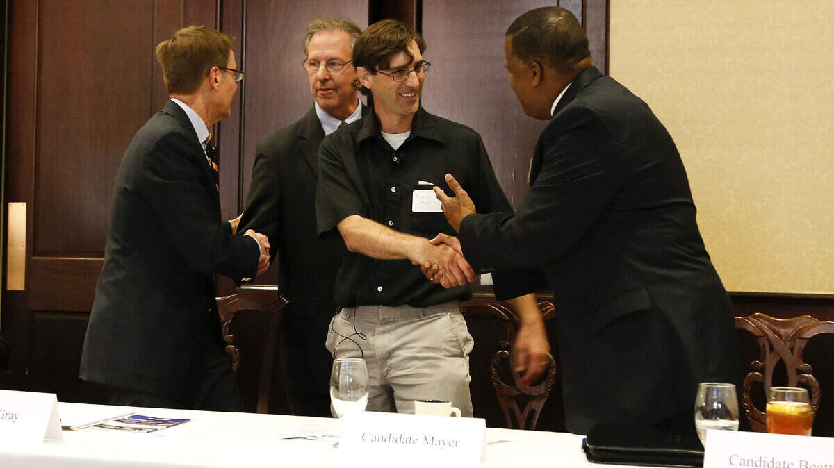 From left, Lexington Mayor Jim Gray shook hands with moderator Tom Martin on Thursday morning and mayoral candidates Danny Mayer and Anthany Beatty shook hands after a mayoral candidate debate at the University of Kentucky hosted by The Lexington Forum. Gray is seeking re-election. The two candidates who receive the most votes in the primary May 20 will face each other in the November election.