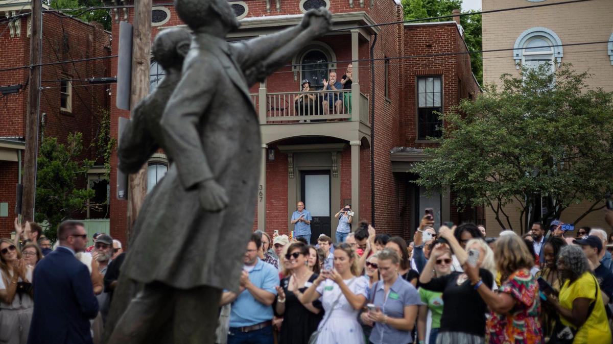 People clap as the figures of Lewis and Harriet Hayden are revealed during the ‘Towards Freedom’ monument unveiling on Thursday, June 19, 2025, at the corner of North Limestone and Fourth Street in Lexington, Ky.