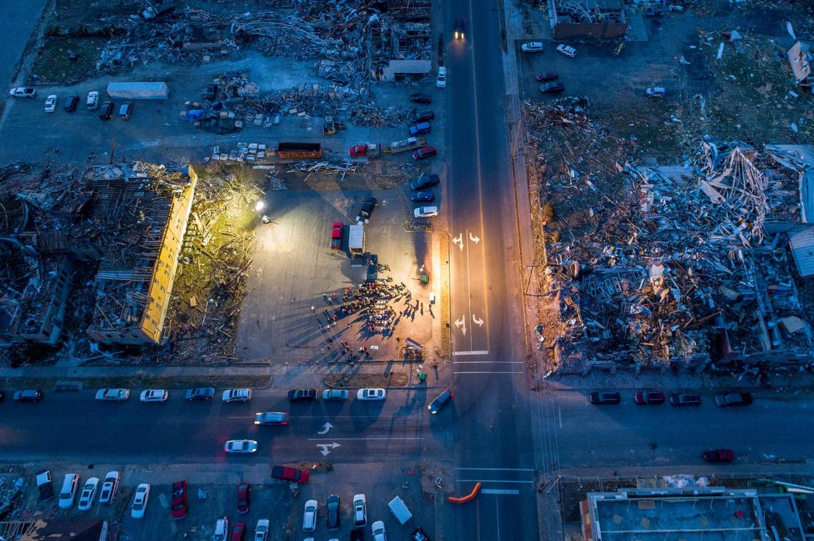 Members of Mayfield First Presbyterian Church and Mayfield First Christian Church gather in an empty lot between their destroyed church buildings for a joint Christmas Eve service in Mayfield. A tornado devastated the community on Dec. 10.