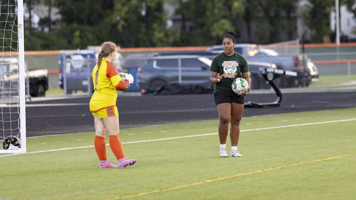 Frederick Douglass assistant coach Maliyah Crump, right, a Broncos alumna, works with goalkeeper Hannah Piatt ahead of their game against Woodford County at The Farm on Wednesday.