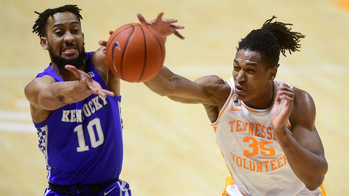 Kentucky guard Davion Mintz (10) and Tennessee guard/forward Yves Pons (35) go for the ball during a basketball game between the Tennessee Volunteers and the Kentucky Wildcats at Thompson-Boling Arena in Knoxville, Tenn., on Saturday, Feb. 20, 2021.