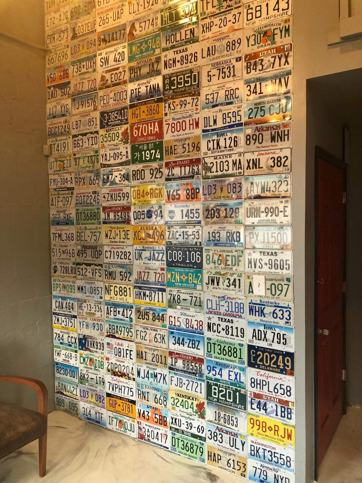 License plates from various states hang on the wall as part of the gas station decor at Rosemont Station in Lexington.