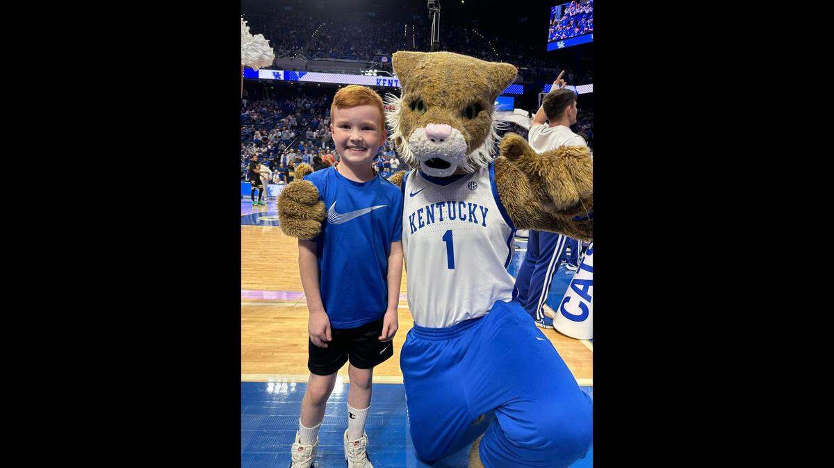 Eli Hill poses for a photo with the Kentucky Wildcats’ mascot at a basketball game. Eli died March 20, 2023 in an incident while playing basketball at his home.