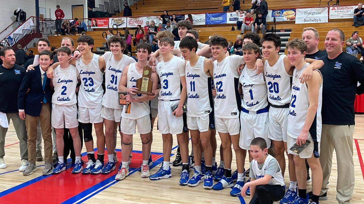 Lexington Catholic poses with its 43rd District Tournament championship trophy after defeating Paul Laurence Dunbar 47-44 at Lafayette High School on Friday night.