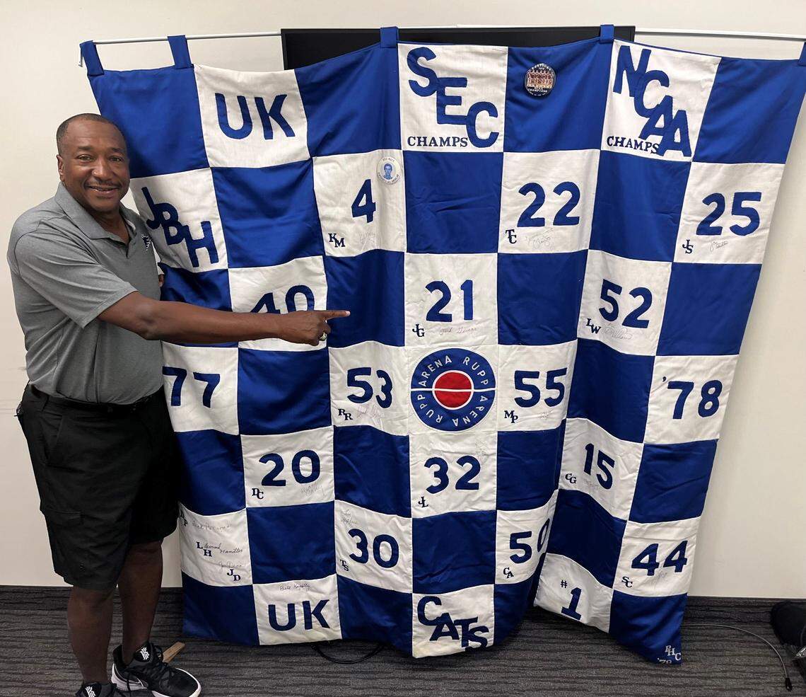 Jack Givens, star of Kentucky’s 1978 NCAA championship team, poses with a quilt sewn by Phyllis Cronin. The quilt, autographed by every player and coach on the 1977-78 Wildcats, can be won via a $50-a-ticket raffle to support Camp Horsin’ Around, a non-profit organization that provides an outdoor camp adventure for children whose health is compromised or who have special needs.