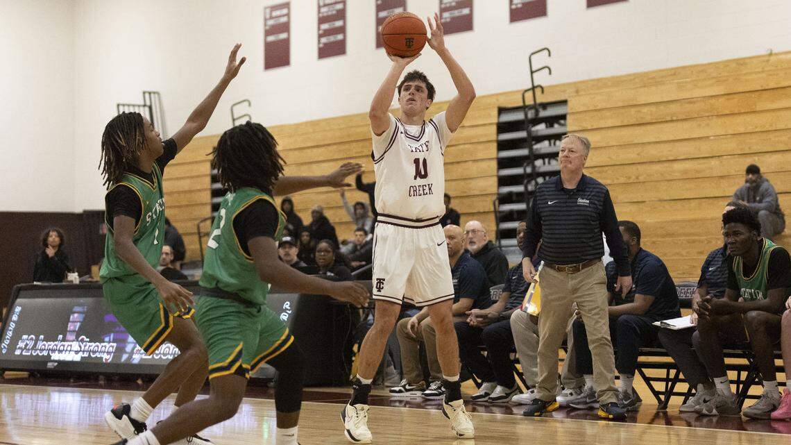 Tates Creek's Tom Haubenreich (10) shoots a 3-pointer over Bryan Station's Brayden Payne (2) and Bryan Station's Marcellus Ashford (1) during KHSAA boys basketball game, Thursday, Jan. 8, 2026 at Tates Creek High School in Lexington, Ky.