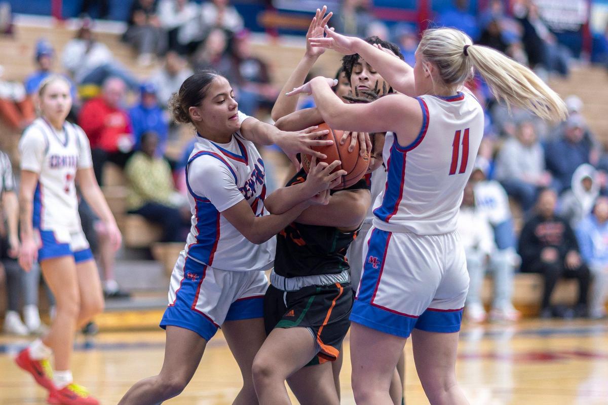 Madison Central’s Nataya Strader, left, fights for a loose ball against Frederick Douglass during Friday’s game in Richmond.