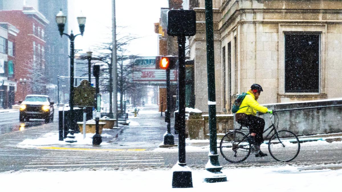 A man rides his bike during the snowstorm downtown Lexington on Tuesday, February 11, 2025, in Lexington, Ky.