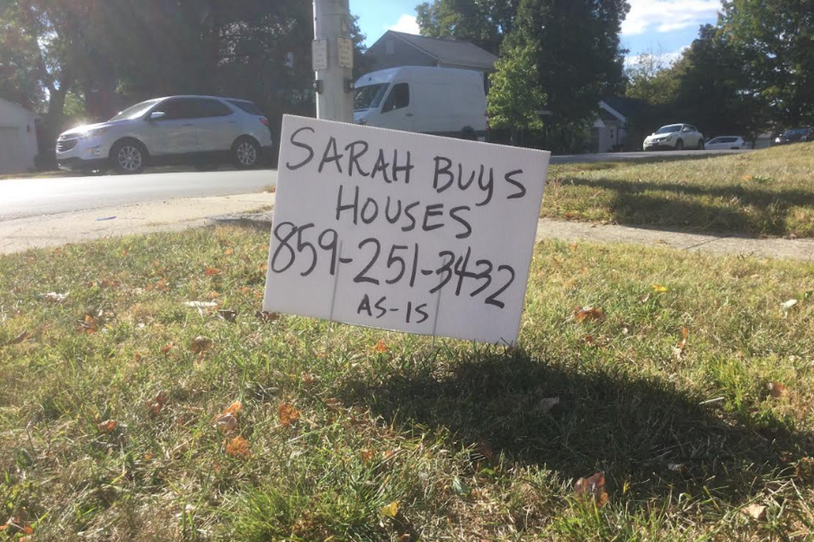 A roadside sign advertising the offer of a housing investor, posted on Henry Clay Boulevard in Lexington.