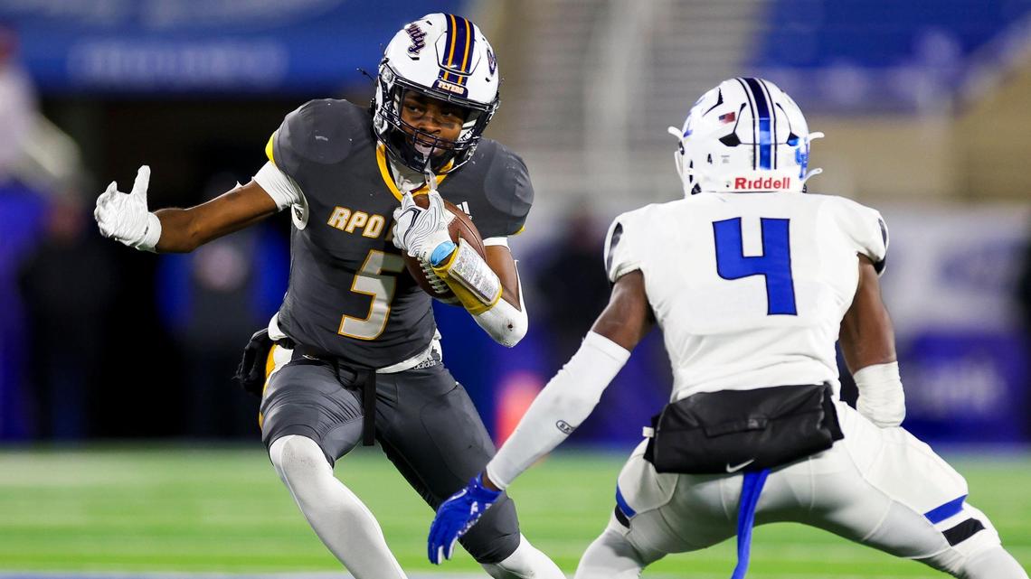 LeDarrius Simmons (5) tries to elude Paducah Tilghman’s Martels Carter (4) on Friday night. Simmons led Franklin County with 138 all-purpose yards.