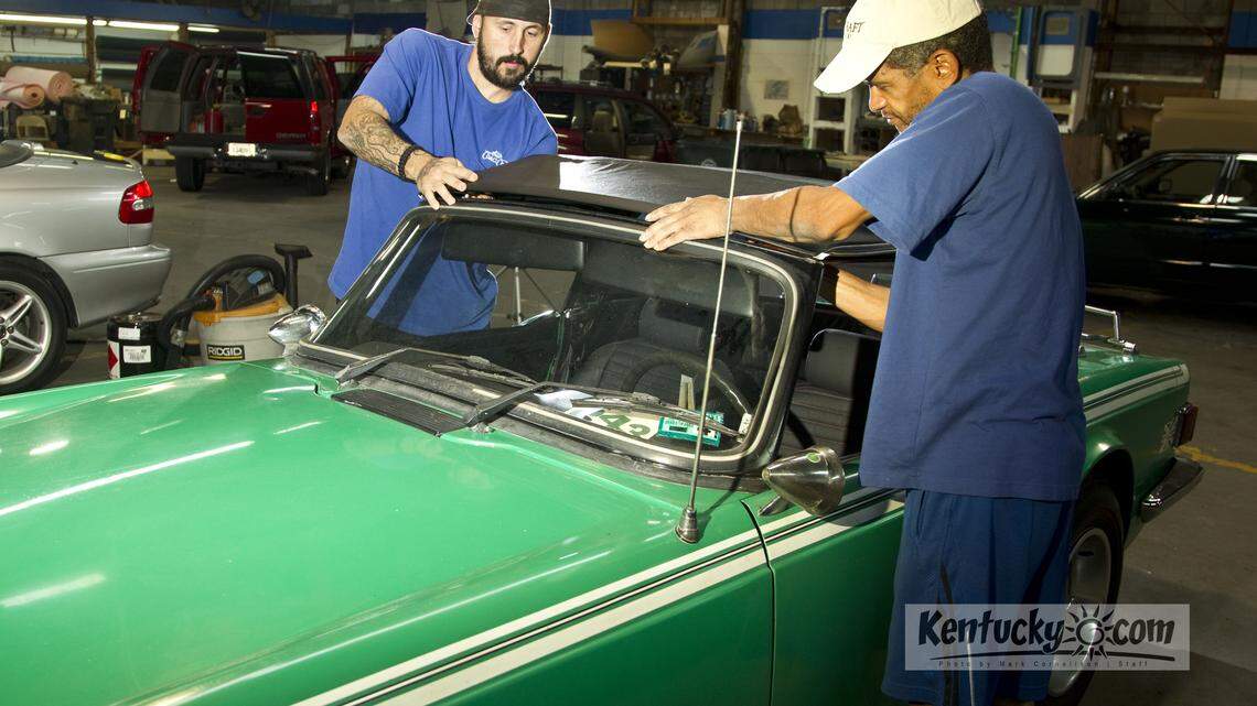 Jonas Taulbee, left, Ruben Rodriguez, right work on a soft top on a vintage Triumph, at Coach Craft  which is  moving from their longtime Main Street home to Floyd Street in  mid-September  photographed  on Tuesday September 4, 2012 in Lexington, Ky.  Photo by Mark Cornelison | Staff