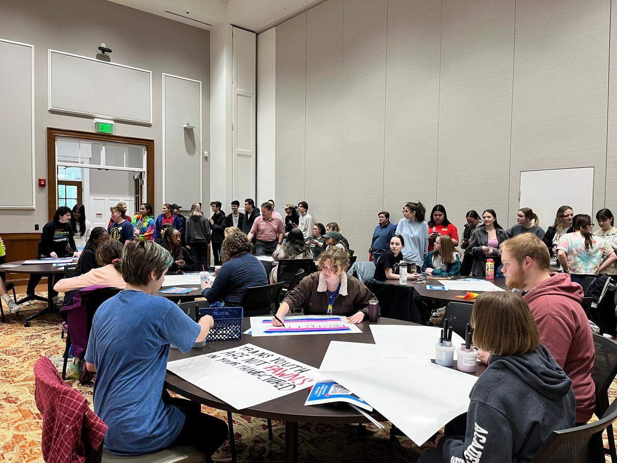 Attendees at a rally for transgender rights at Transylvania University on Friday, March 3, 2023, make posters before the rally begins. The event was planned in response to recent anti-LGBTQ legislation introduced in Kentucky.