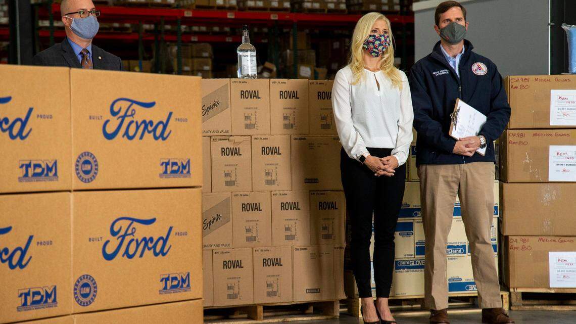 Gov. Andy Beshear stands with First Lady Britainy Beshear after speaking during a press conference at the KDPH warehouse announcing a donation of 2 million masks from the Ford Motor Company to help build KentuckyÕs stock of Personal Protective Equipment in Frankfort, Ky., Monday, September 14, 2020.