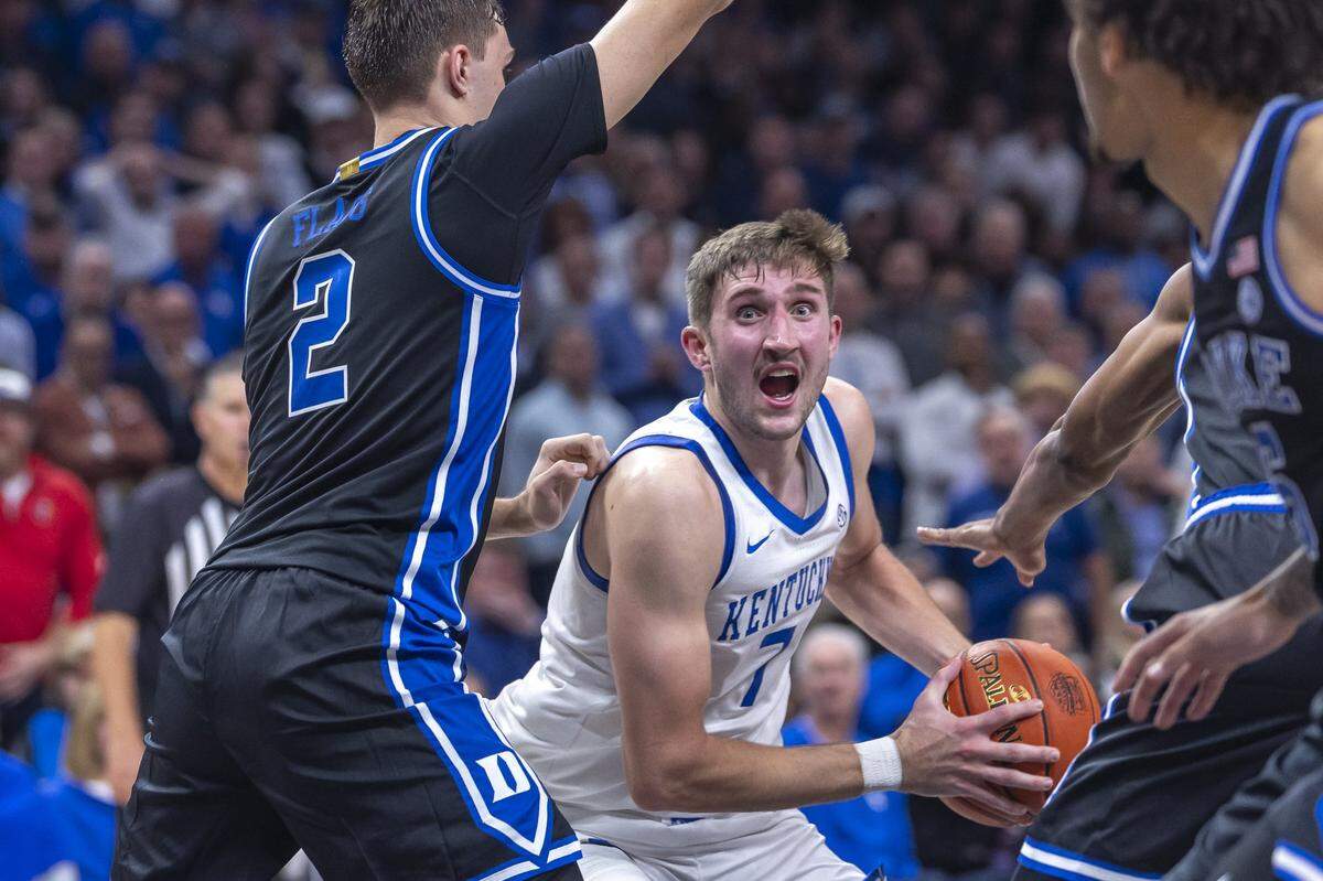 Kentucky forward Andrew Carr (7) looks to move the ball as Duke’s Cooper Flagg (2) defends during Tuesday’s game in the Champions Classic at State Farm Arena in Atlanta.