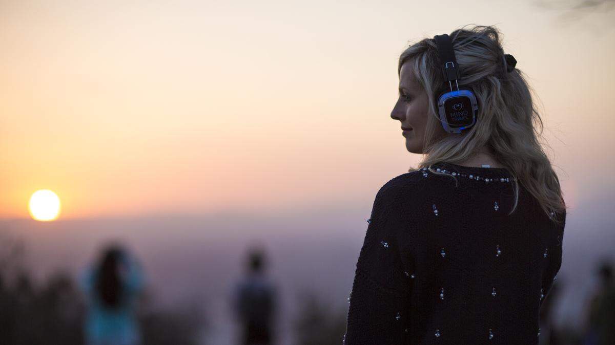 Participants at SilentHike wear headphones to listen to composer Murray Hidary’s music and his commentary. The Lexington evening hike will be at McConnell Springs Park.