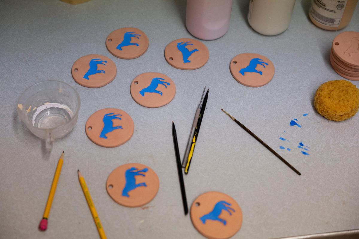 Student-workers start to create ceramic goods to fulfill orders at Matchstick Goods, a subsidiary of non-profit Common Good, at the workshop in Embrace Church in Lexington, Ky, Thursday, November 30, 2023. The North Lexington youth work on arts projects that can be sold at market and provide them with workplace experience.