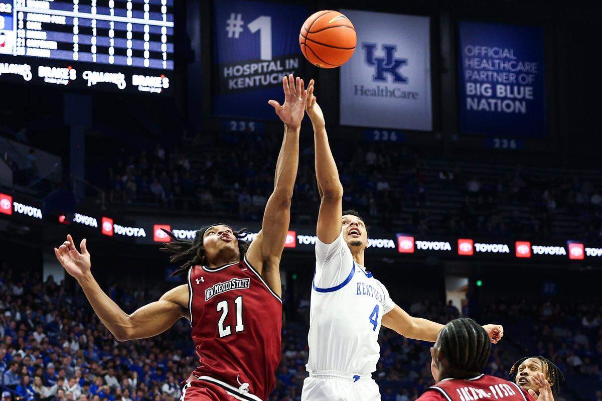 Kentucky’s Tre Mitchell (4) reaches for a rebound against New Mexico State’s Robert Carpenter (21) on Monday night. The transfer from West Virginia led UK with nine rebounds in his Wildcats debut.