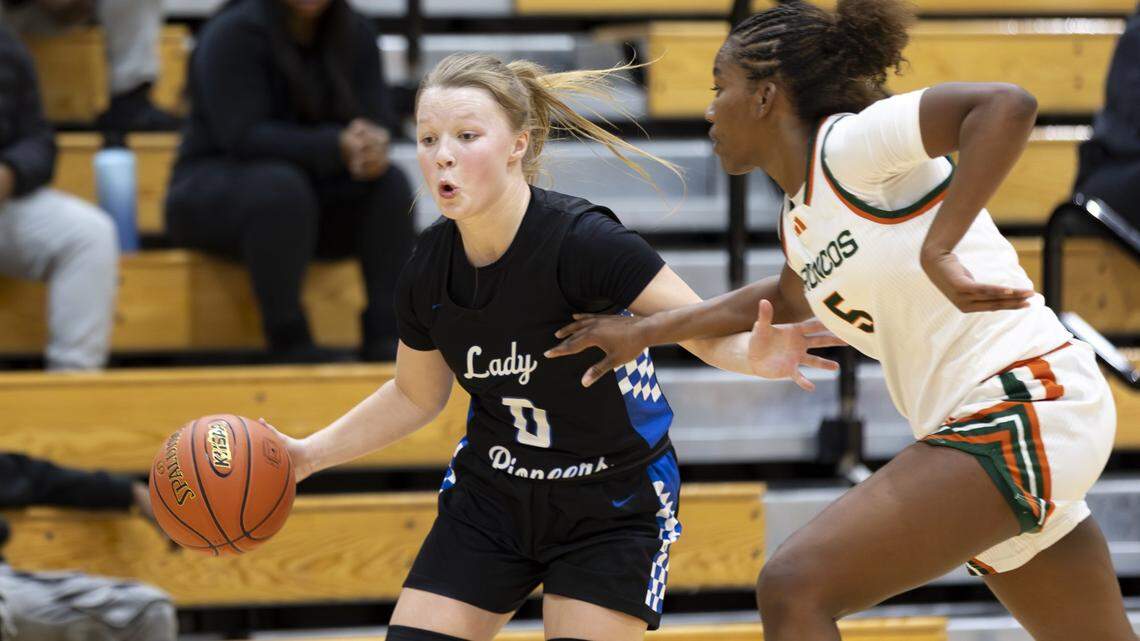 Simon Kenton’s Brynli Pernell looked to drive down the baseline against Frederick Douglass’ Peighton Okorley during the Pioneers’ 53-47 win at The Farm on Feb. 9. The Pioneers and Broncos are part of this week’s Girls’ Sweet 16.
