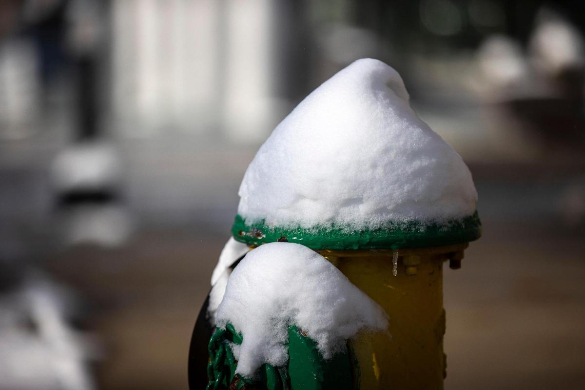 Snow covers a fire hydrant in downtown Lexington, Ky., on Saturday, March 12, 2022. The National Weather Service reported 4.5 inches of snow fell on Friday night.